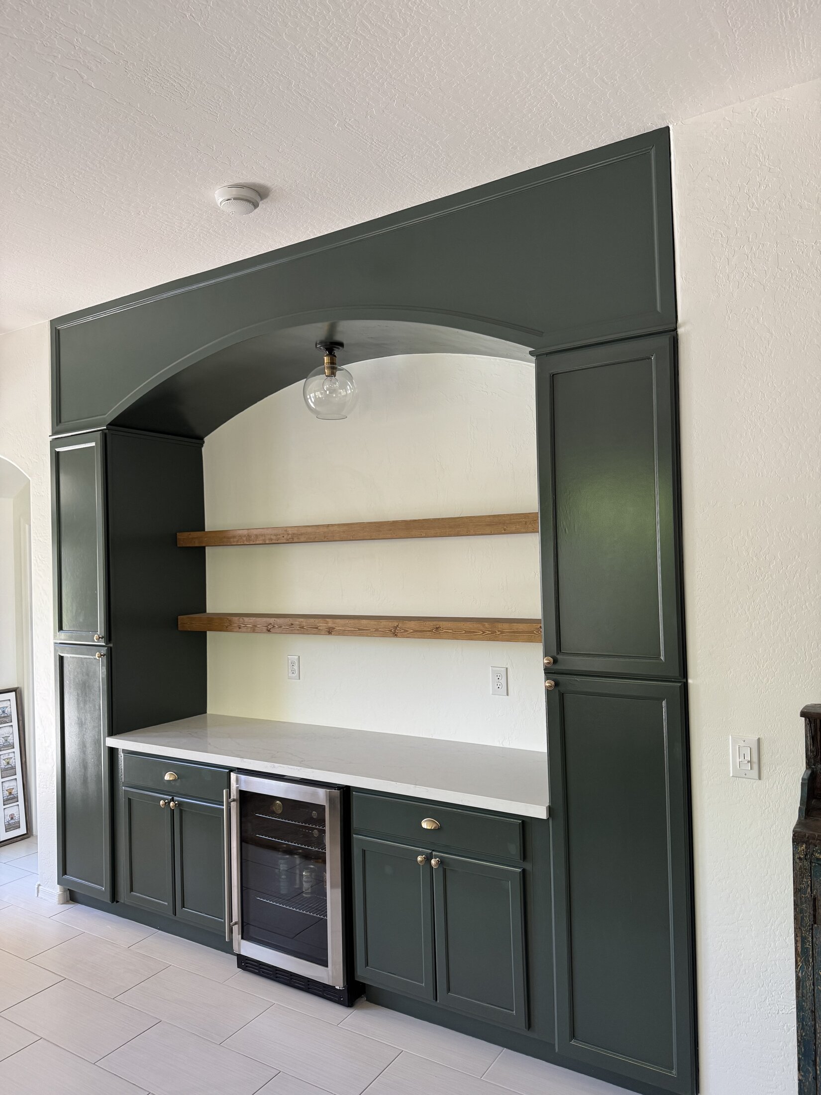 Custom built-in wet bar with arched cabinetry, JBS whole-home remodel