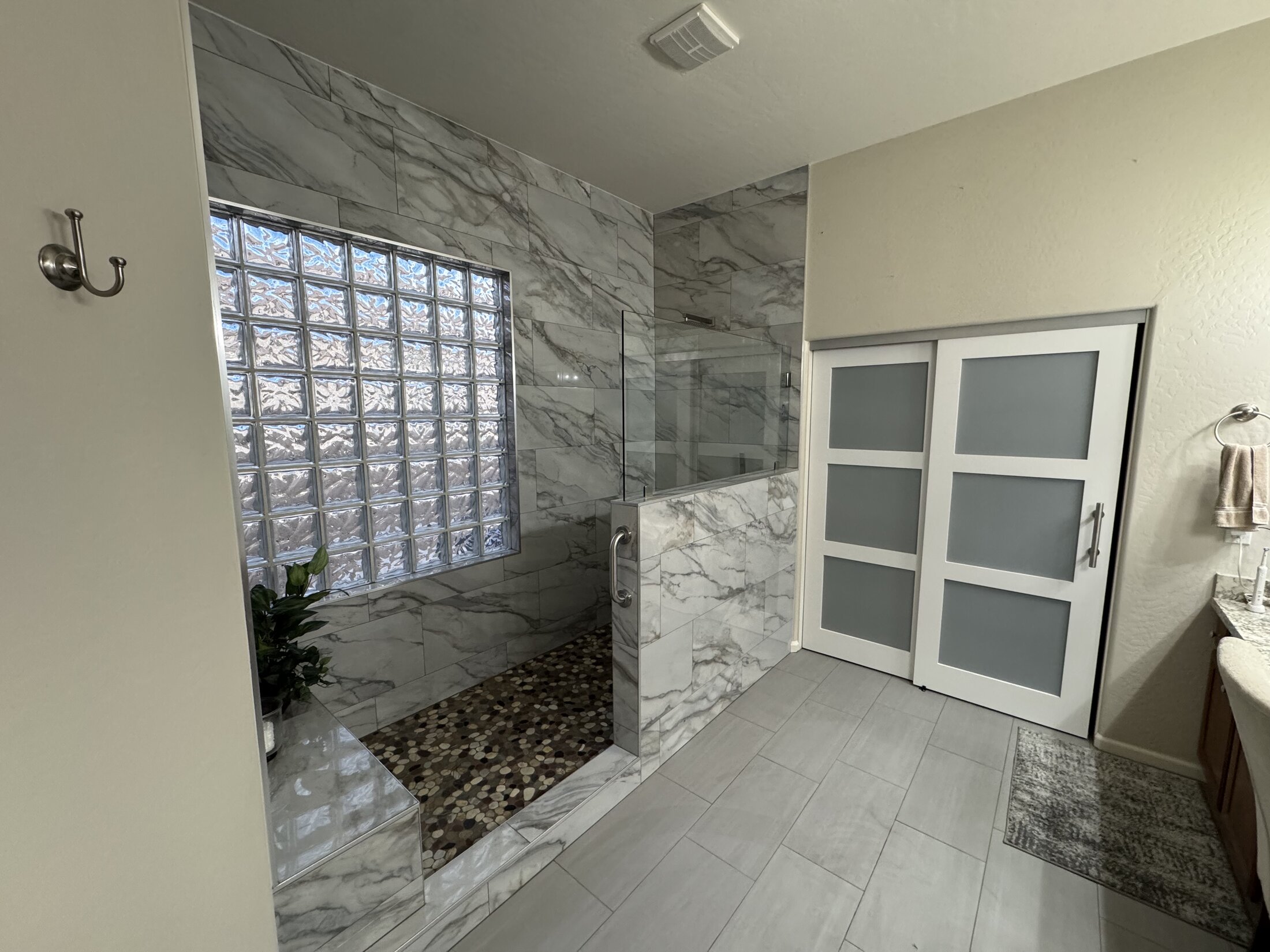 Custom marble walk-in shower with glass block window, JBS bathroom remodel in Litchfield Park AZ